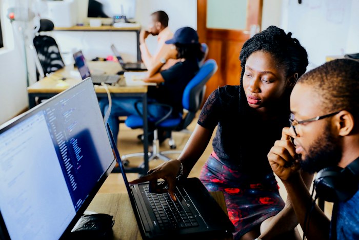 Engineering team working together at computers